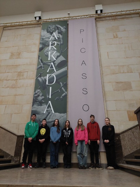 7 uczniów stoi przy schodach, z tyłu napis Picasso