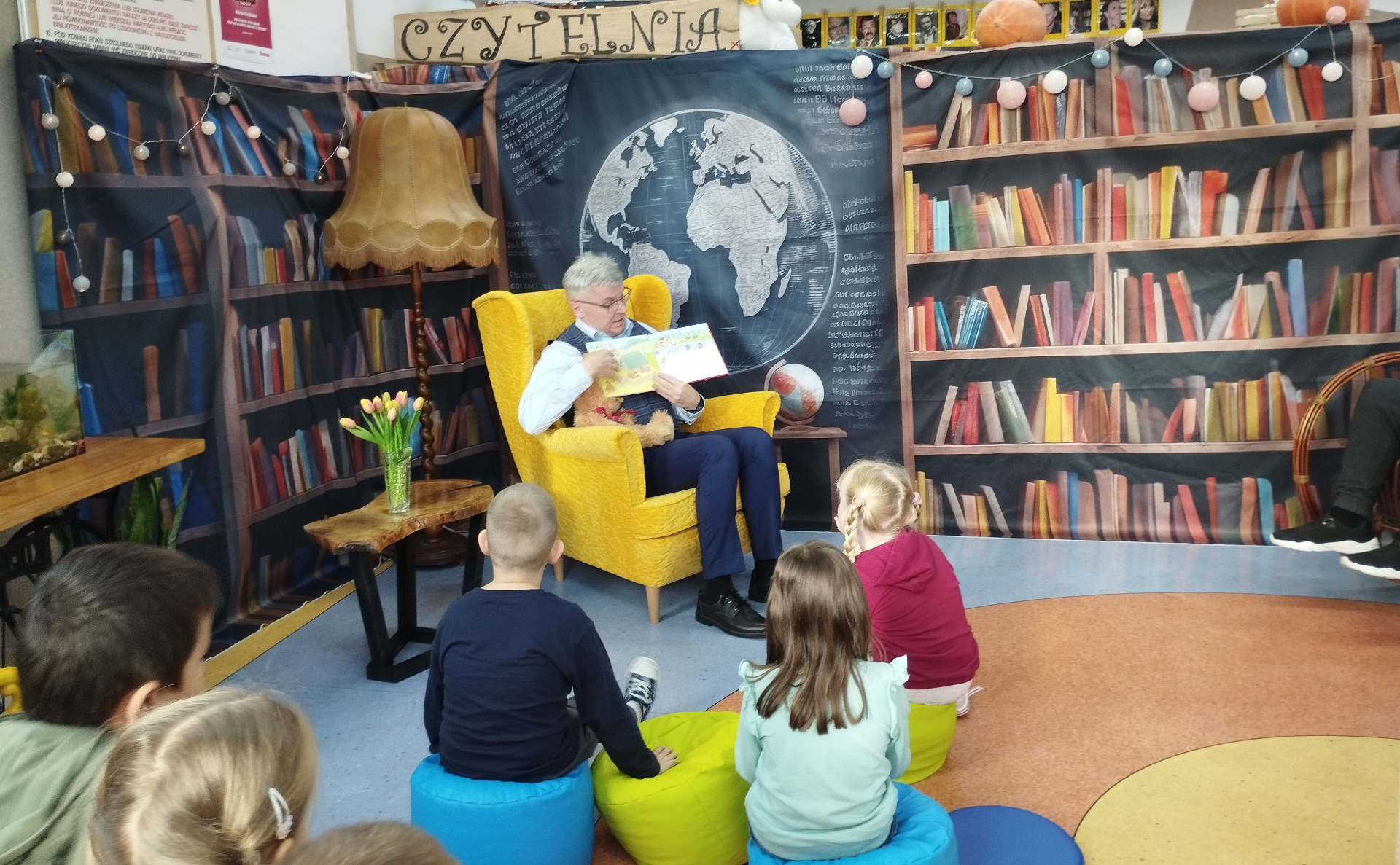 Dyrektor szkoły czytający dzieciom 
